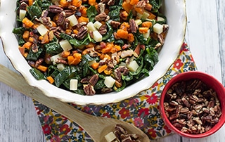 Big bowl of Kale Salad with Pecans, Sweet Potatoes, and Apples.