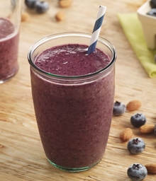 Blueberry Almond Smoothie with striped straw.
