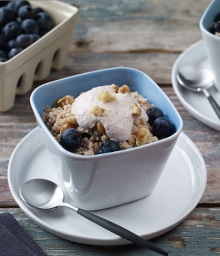Square bowl of Breakfast Quinoa with Blueberries.