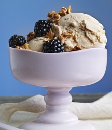 Bowl of Brown Butter Walnut Ice Cream topped with blackberries and Diamond nuts.