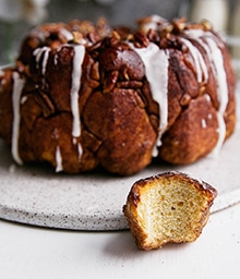 Buttered Rum Monkey Bread with one piece pulled out.