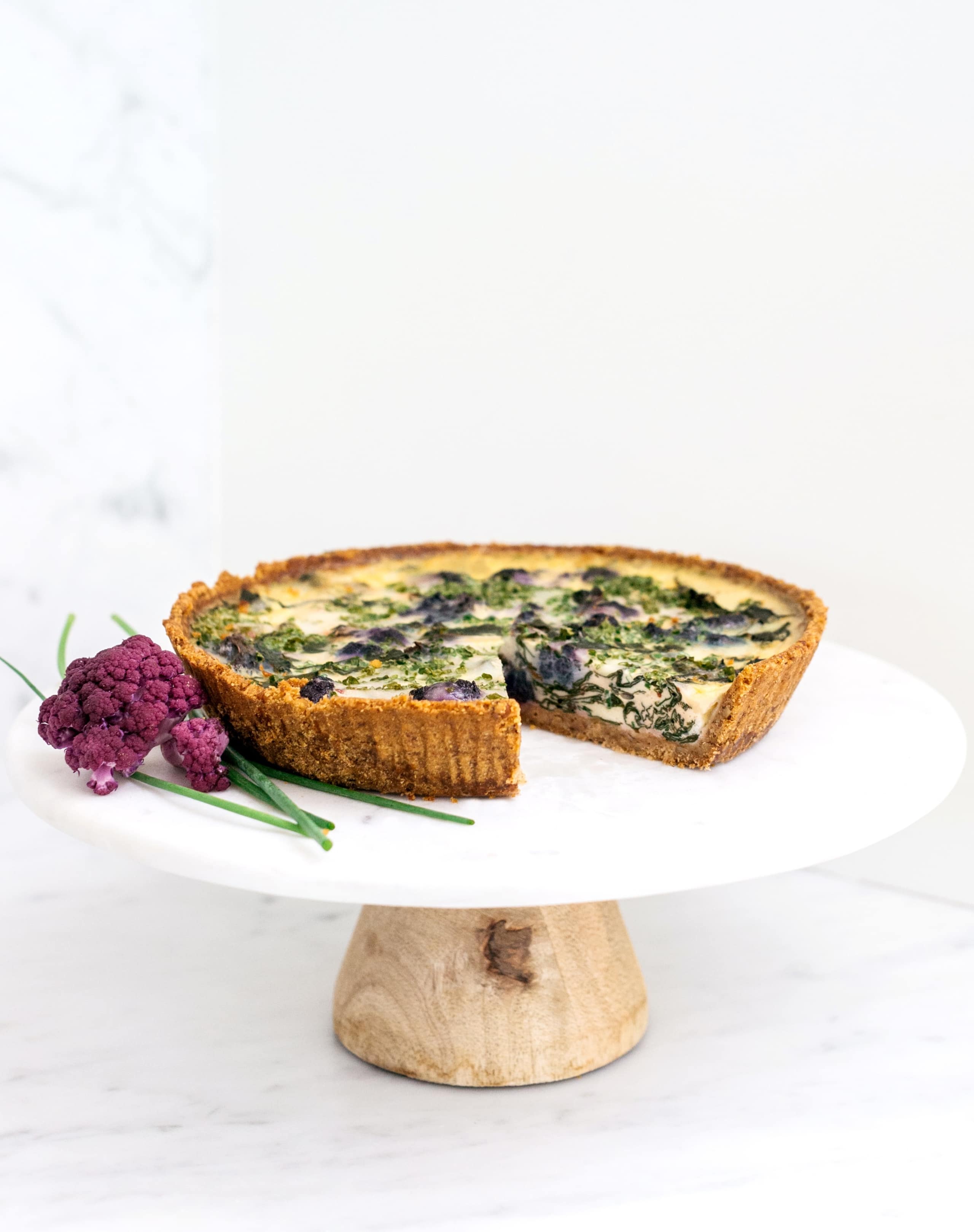 Raised display plate of Cauliflower Quiche with Diamond Walnut Pie Crust.