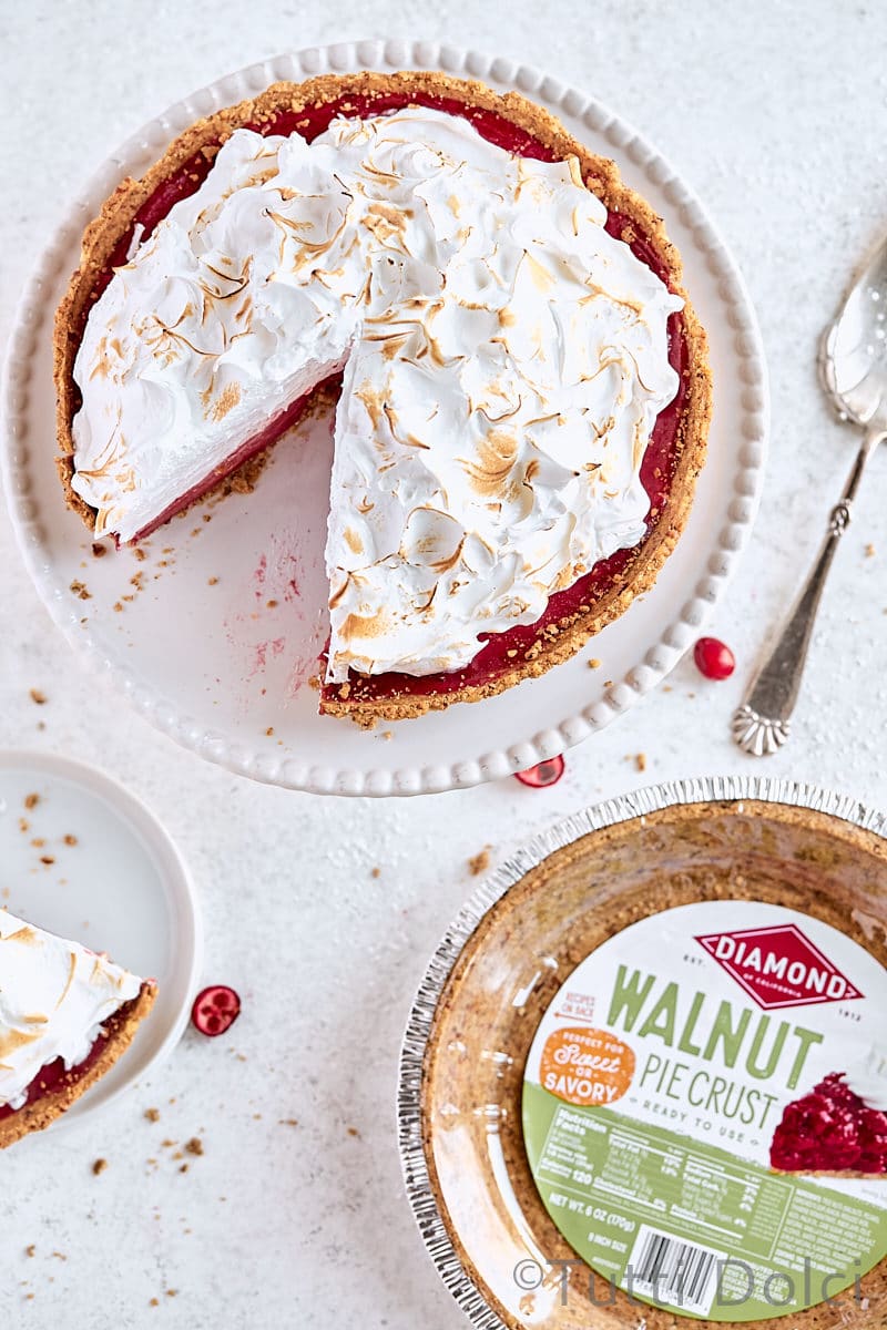 Cranberry Walnut Meringue Pie with a slice taken out.