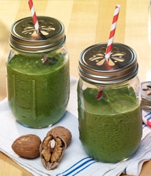 Two mason jars with Creamy Green Walnut Shakes.