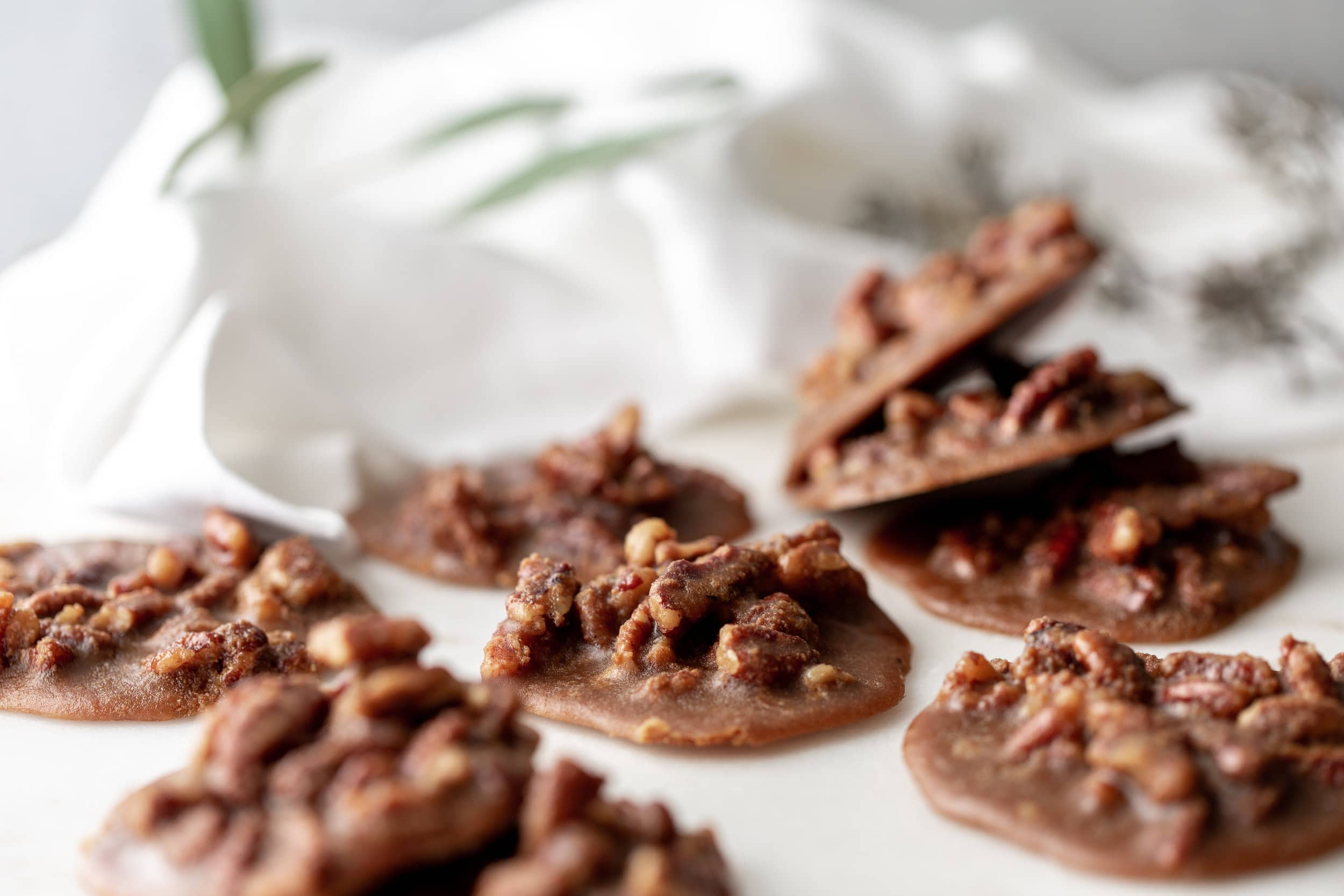 Close-up of several Creamy Bananas Foster Pecan Pralines.