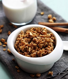 Bowl of Cinnamon Pumpkin Granola and glass of milk.