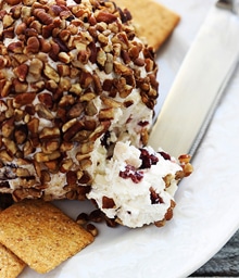 Cranberry Pecan Cheeseball next to crackers.