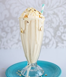 Old-fashioned glass overflowing with Honey Almond Milkshake.
