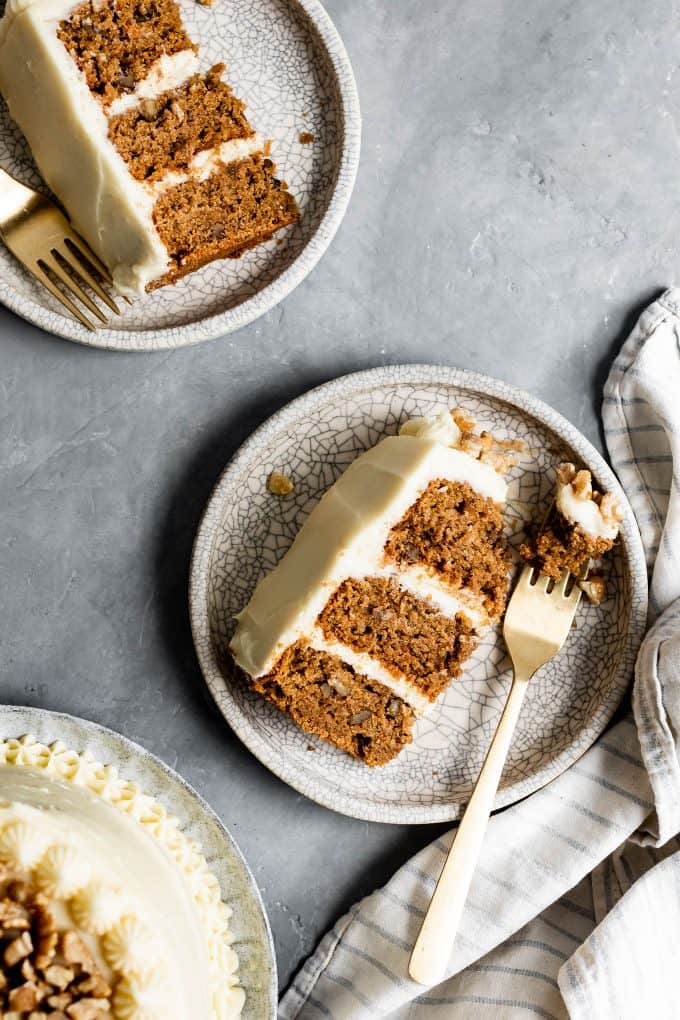 Two plates with slices of Gluten-Free Carrot Cake with walnuts.