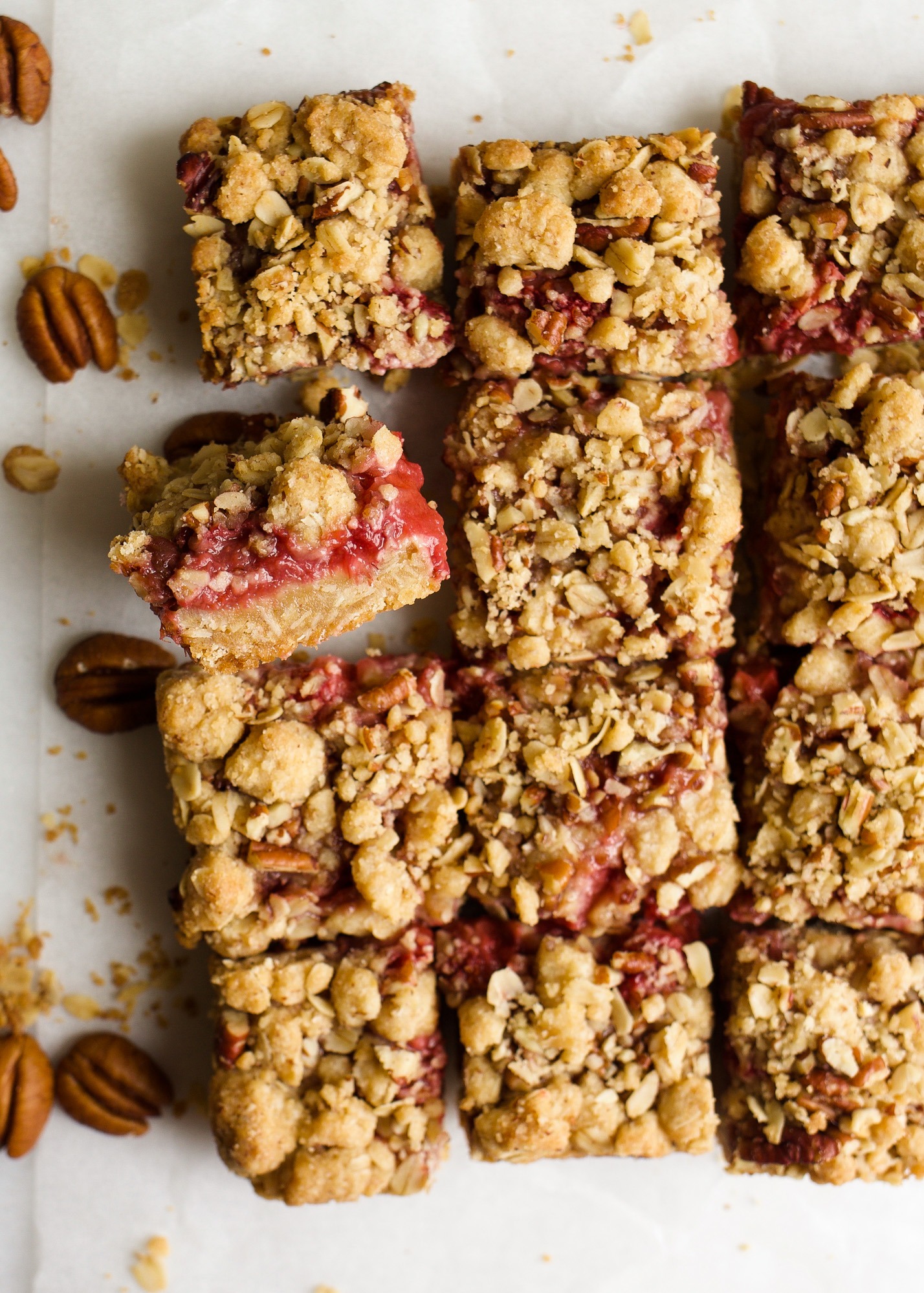 A dozen sliced Strawberry Rhubarb Crumb Bars.