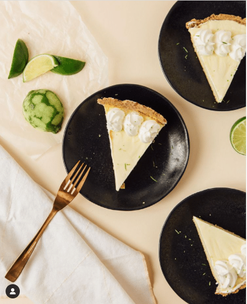 Three plates with slices of Keto Key Lime Pie.