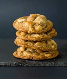 Stack of Macadamia White Chocolate Chunk cookies.