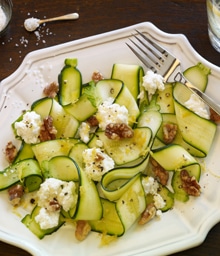 Plate of noodled zucchini with ricotta and Diamond nuts.