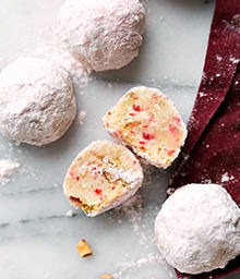 Peppermint Pecan Snowball Cookies, one broken in half.