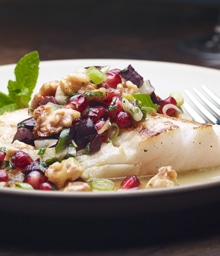 Roasted Orange Citrus Halibut topped with pomegranate and Diamond nuts.