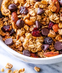 Bowl of Sallys Baking Granola with nuts and chocolate chips.