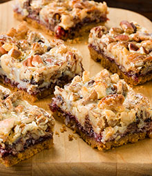 Squares of Seven Layer Magic Cookie Bars on cutting board.