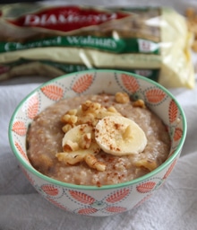 Bowl of Stephie Cooks' Banana Oatmeal topped with bananas and walnuts.