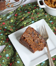 Slice of Stephie Cooks' Christmas Spice Cake on festive tablecloth.