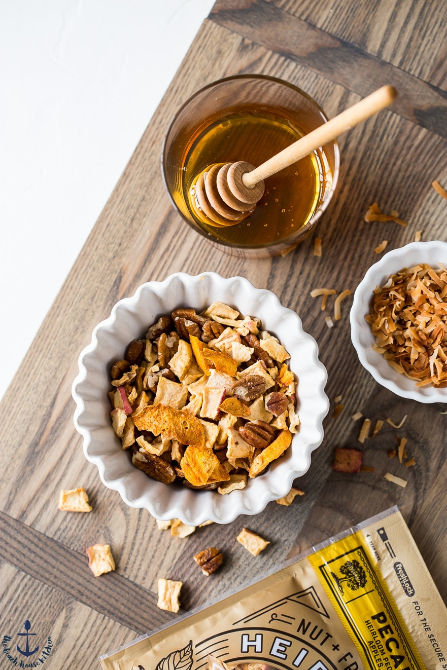 Bowl of Peachy Quinoa Breakfast Bowls and bowl of honey.