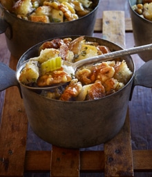 Spoon dipping into bowl of Walnut and Apple Herb Stuffing.