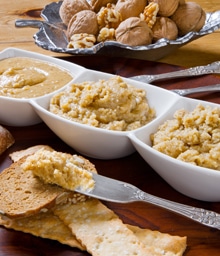 Three bowls of walnut butter with different consistencies.