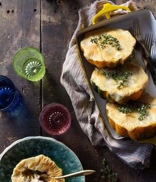 Pan with three Acorn Squash Pot Pies and one on a plate.