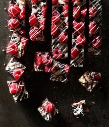 Walnut and Chocolate Cake Bars topped with raspberries and drizzled white chocolate.