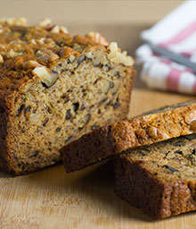 Loaf and slices of Best Banana Bread on cutting board.