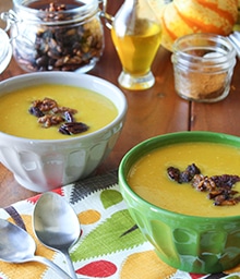 Two bowls of Butternut Squash Soup with Maple Spiced Walnuts.