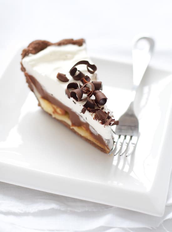 One slice of Chocolate Banana Cream Pie topped with chocolate curls.