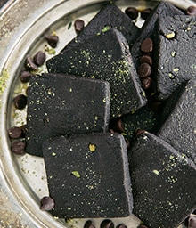 Plate of Dark Chocolate Shortbread Cookie Squares with Pistachios.