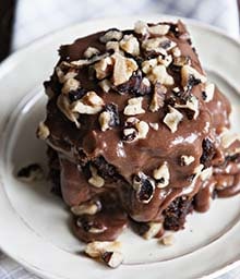 Plate with Decadent Frosted Brownies covered in Diamond nuts.