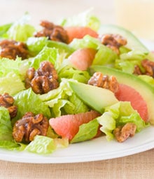 Green salad with avocado, grapefruit, and glazed walnuts.