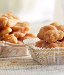 Two muffin wrappers filled with Cinnamon Glazed Walnuts.