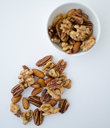 Espresso Glazed Nuts in a bowl and on counter.