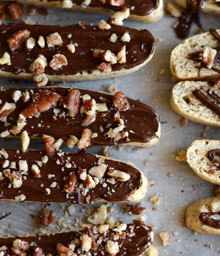 Top view Flourless Almond Biscottis topped with chocolate and nuts.