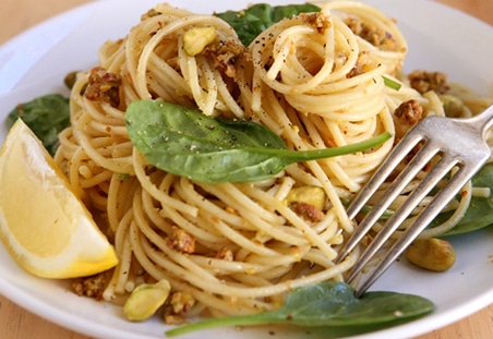 Plate of Diamond Nuts Lemon Pistachio Spinach Spaghetti.