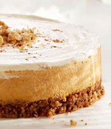 Layered Pumpkin Walnut Cheesecake topped with Diamond nuts.