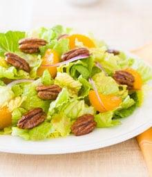 Romaine salad with glazed pecans and mandarin oranges.