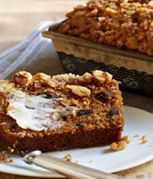 Piece of Spiced Pumpkin Bread with Walnuts smeared with butter.