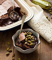 Bowl of Toffee Earl Grey Brownie Pudding topped with pistachios.