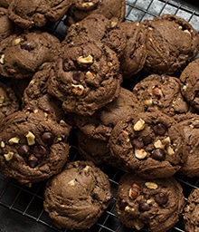 Pile of Chocolate Espresso Toasted Hazelnut Cookies on cooling rack.