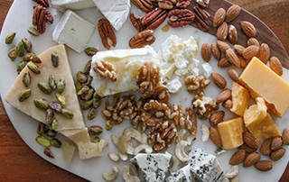 Tray of various cheese and nut pairings.