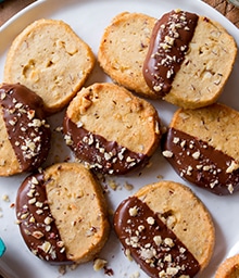 Plate of Toasted Hazelnut Slice and Bake Cookies dipped in milk chocolate.