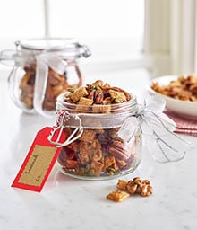 Small jars of Holiday Nut Mix with gift tag.