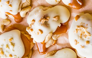 White Chocolate Caramel Clusters topped with crushed cashews.
