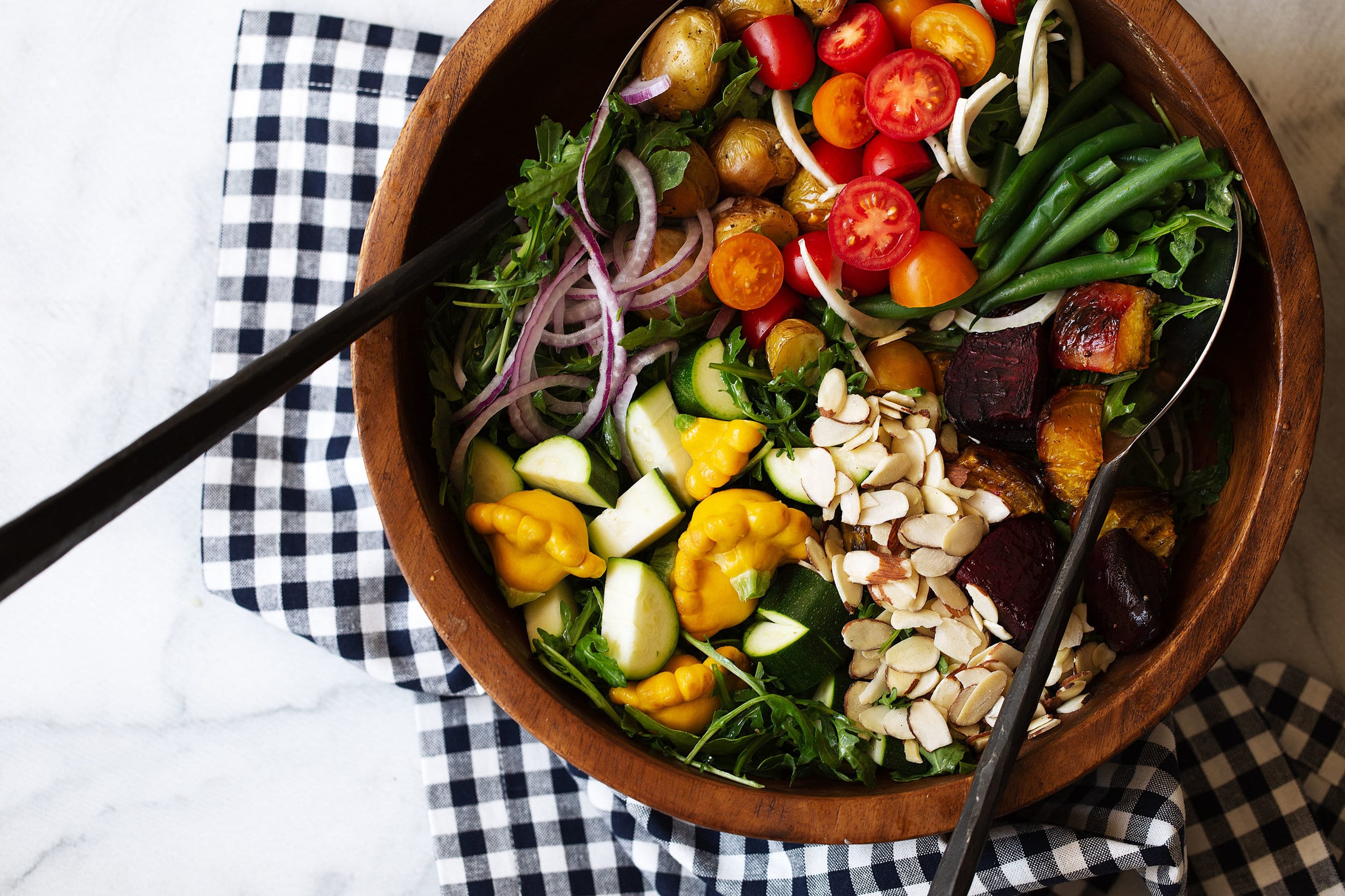 Big bowl of Kitchen Sink Salad with sliced almonds.