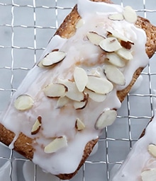 Frosted Lemon Almond Pound Cake on cooling rack.