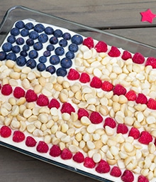 Cake with American flag design made of macadamia nuts and berries.